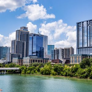 Downtown skyline of Austin, Texas, the USA. Colorado River and skyscrapers on blue sky